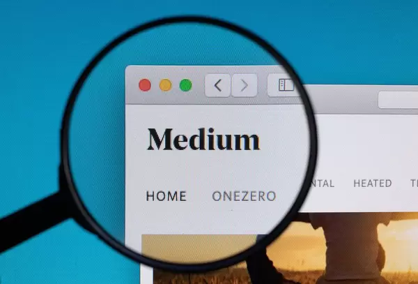 Medium logo under magnifying glass