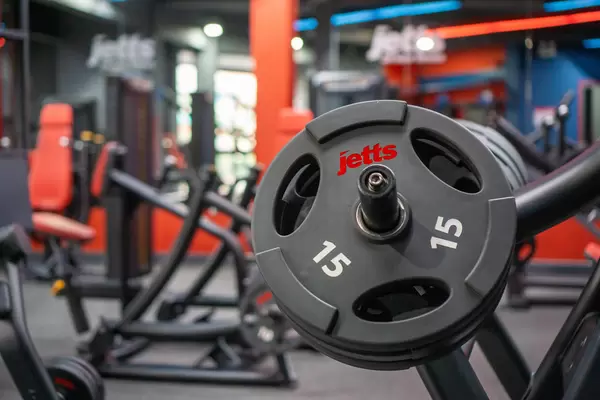 Mehrere Gewichtsscheiben auf einer Latzug Maschine in einem modernen Fitnessstudio Nahaufnahme