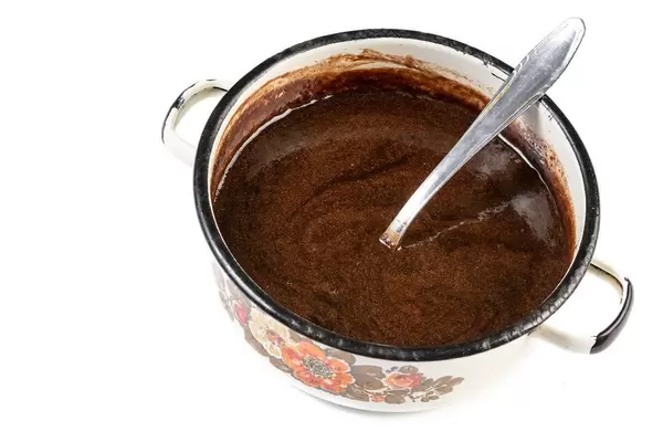 Melted Chocolate in the pot with spoon