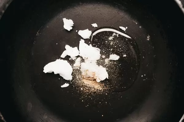 Melting honey, coconut oil and ginger in a pan