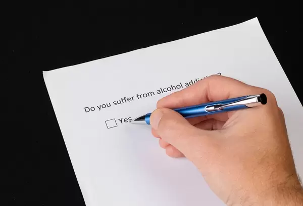 Men answering question if he suffer from alcohol addiction