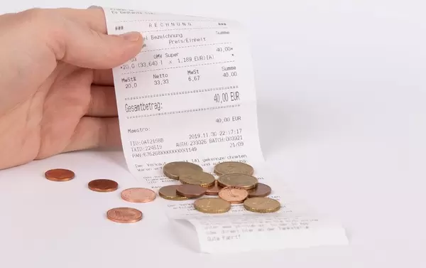 Men Holding Receipt with coins