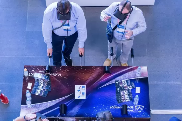 Men playing VR foosball