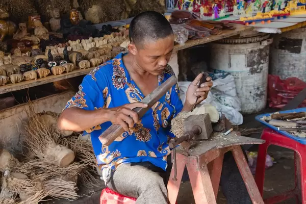 Men sculpting wood at the  Marke Vietnam.
