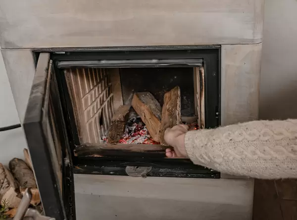 Men Setting  A Fire On Fireplace