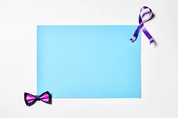 Men's bow tie and ribbon with blank blue paper