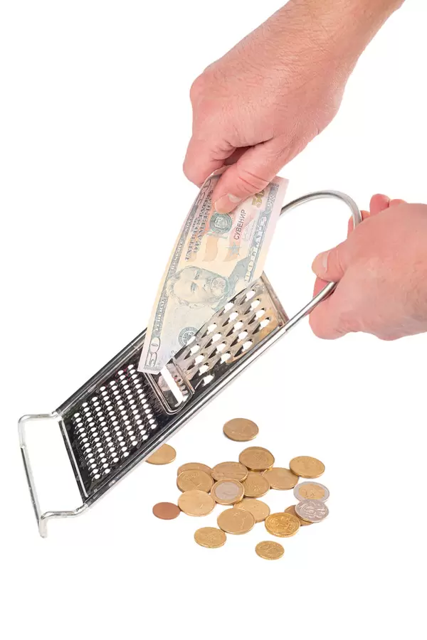Men's hands with a grater and dollars, the concept of inflation