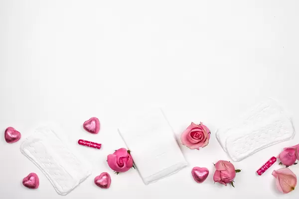 Menstrual hygiene products: panty liners, pads, tampons on white background with space for text