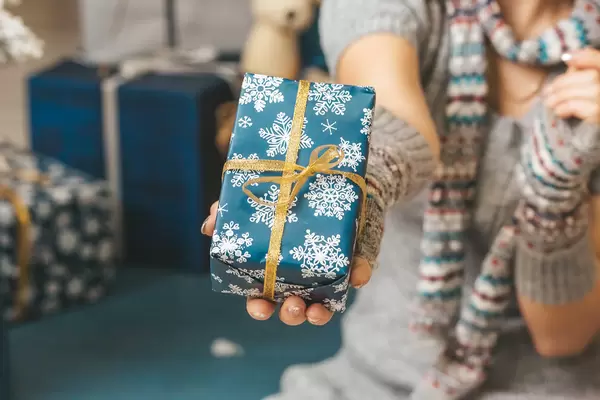 Merry christmas background with gift in hand