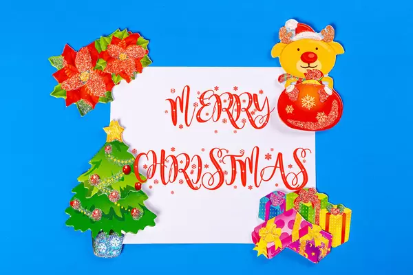 Merry christmas greeting lettering with gifts, christmas tree and deer