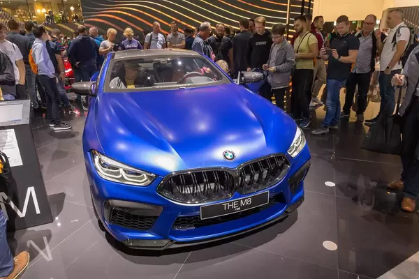 Messebesucher fotografieren das BMW 8er Coupé Auto M8 Competition in strahlendem blau