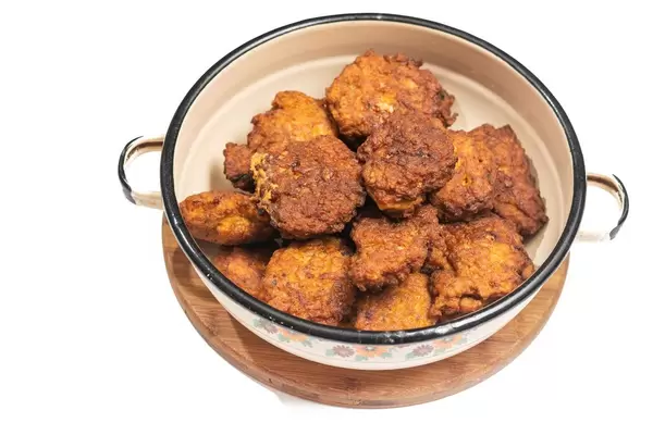 Metal bowl full with meatballs isolated above white background