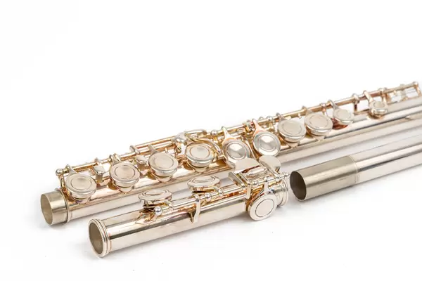Metal Flute parts isolated above white background with copy space