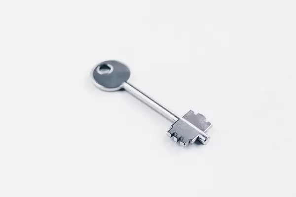 Metal key on white background