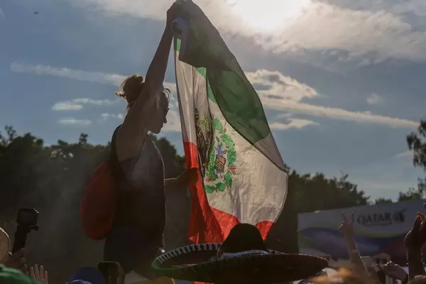 Mexican female soccer fan with flag in hands