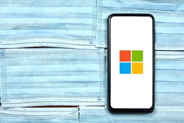 Microsoft company logo on cell phone screen. Coronavirus impact to Microsoft's business