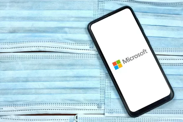 Microsoft company logo on smartphone. Global company during coronavirus crisis