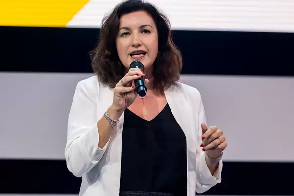 Mid-shot portrait of German Minister of State Dorothee Bär holding a speech with a microphone in her hand on the Digital X stage in Cologne