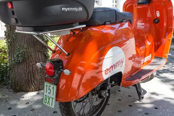 Miet-Elektroroller mit Gepäckkorb für die Umweltschutz auf einer Straße von München