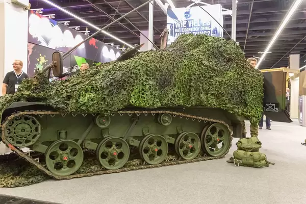 Military track vehicle with forest camouflage