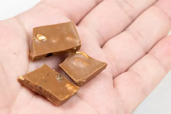 Milka Chocolate bars stacked on the palm of the hand