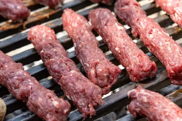 Minced Meat Kebabs grilling on the barbecue (Flip 2019)