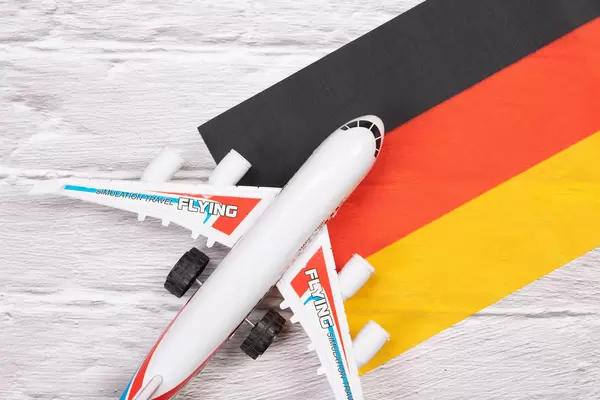 Miniature airplane over flag of Germany