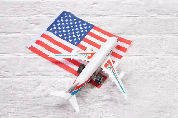 Miniature airplane over flag of USA