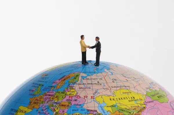 Miniature businessman on the globe