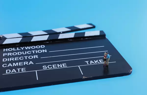 Miniature couple dancing on clapboard