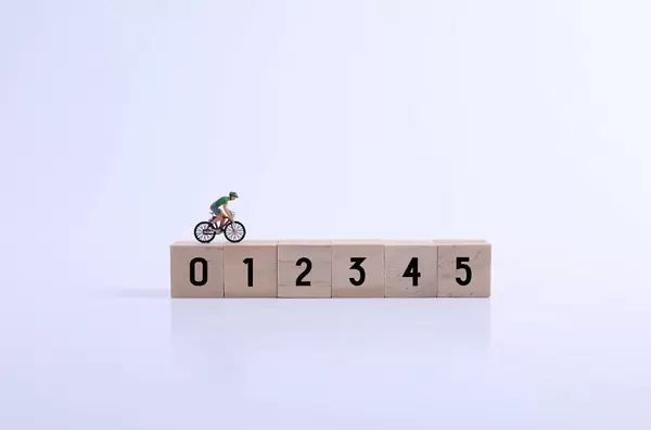 Miniature cyclist on wooden blocks with numbers