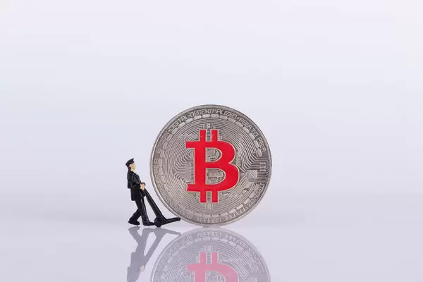 Miniature delivery worker with silver Bitcoin coin