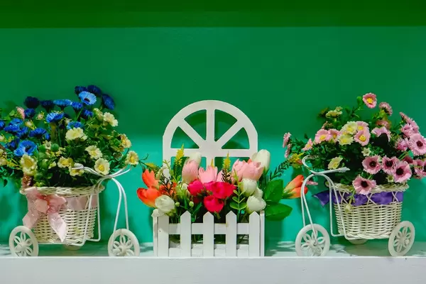 Miniature floral decoration on green wall