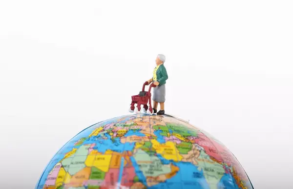 Miniature old woman on globe