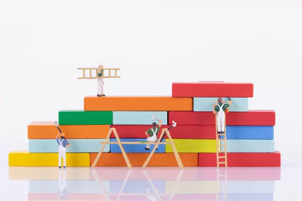 Miniature painter painting a colorful wall