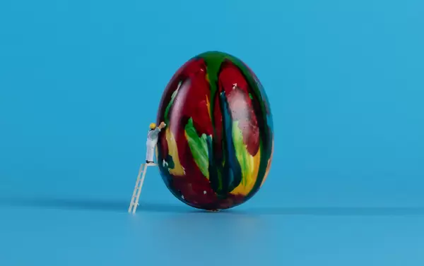 Miniature painter painting easter egg