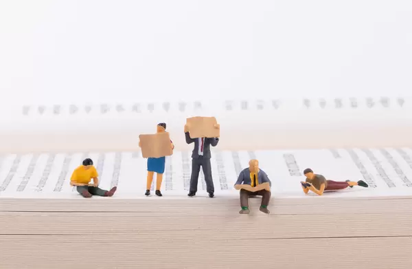 Miniature people on a open book