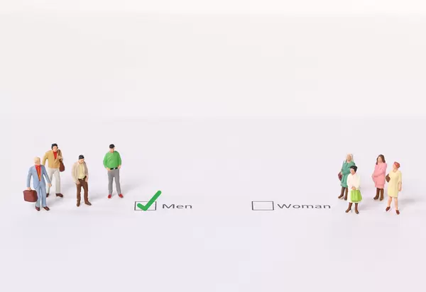 Miniature people standing in front of a check box selected as a MEN