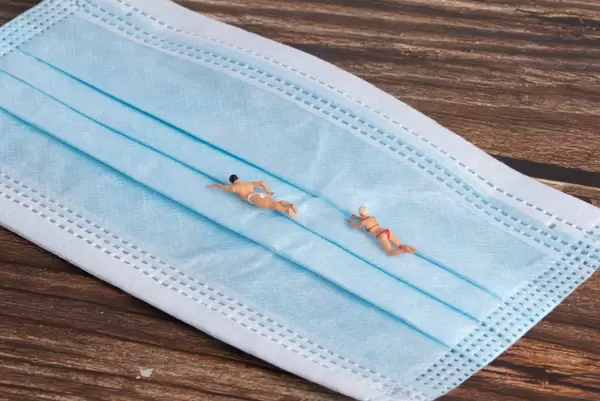 Miniature people swimming on a mask