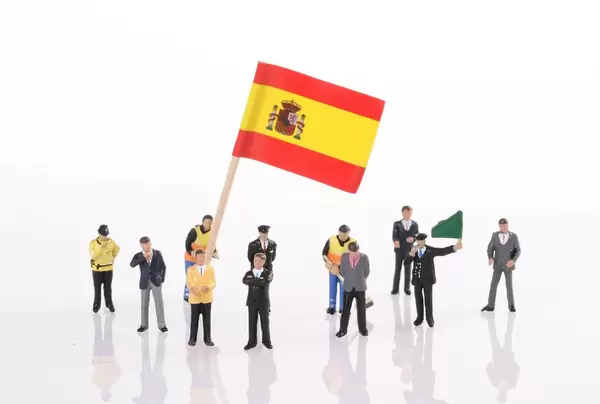 Miniature people with flag of Spain