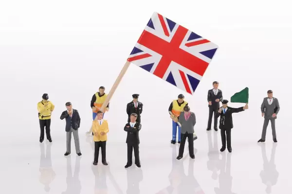 Miniature people with flag of United Kingdom