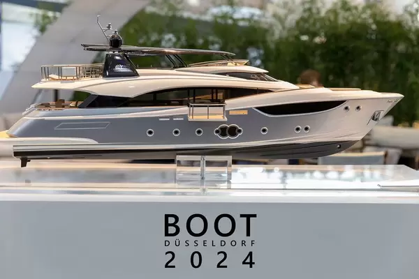 Miniature replica of a luxury yacht, exhibited at the German boat fair next to the title "Boot Düsseldorf 2024"