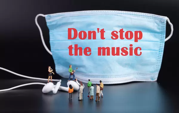 Miniature rock band and medical face mask with Don't stop the music text