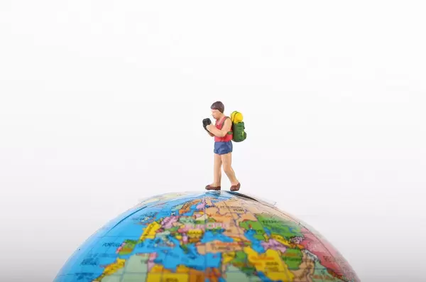 Miniature traveler on globe