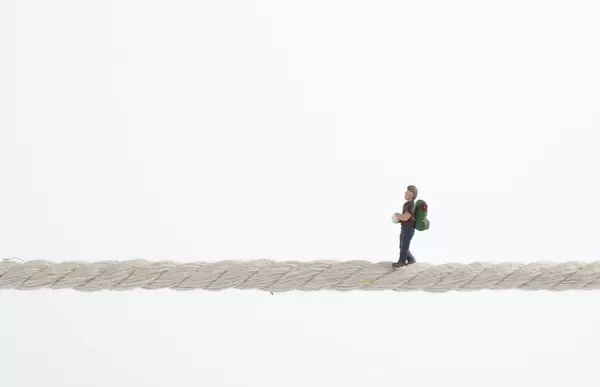 miniature traveler standing on rope
