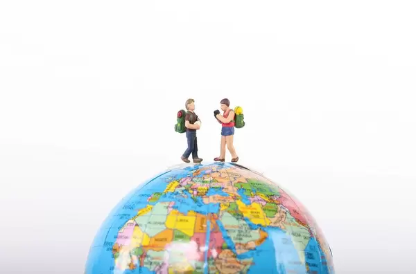 Miniature travelers on globe