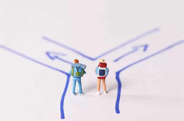 Miniature travelers walking on the path