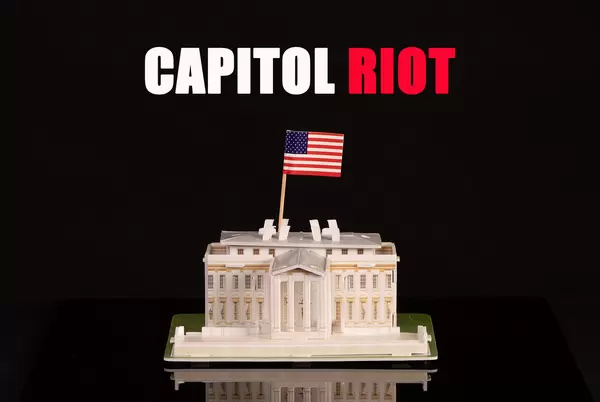 Miniature White House with American flag and Capitol Riot text