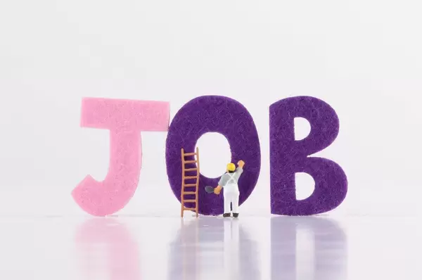 Miniature worker with Job text on white background