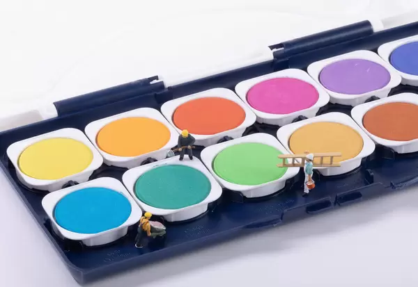 Miniature workers with colorful paints